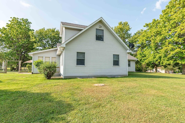 rear view of house with a yard