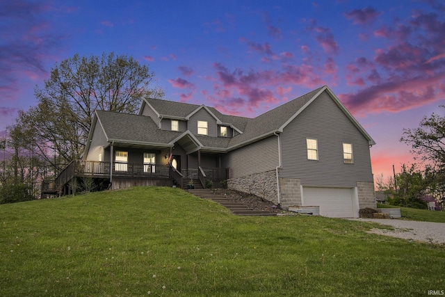 view of front of property with stairs, a garage, a yard, a porch, and gravel driveway