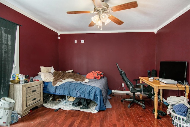 bedroom with wood finished floors, crown molding, ceiling fan, and baseboards