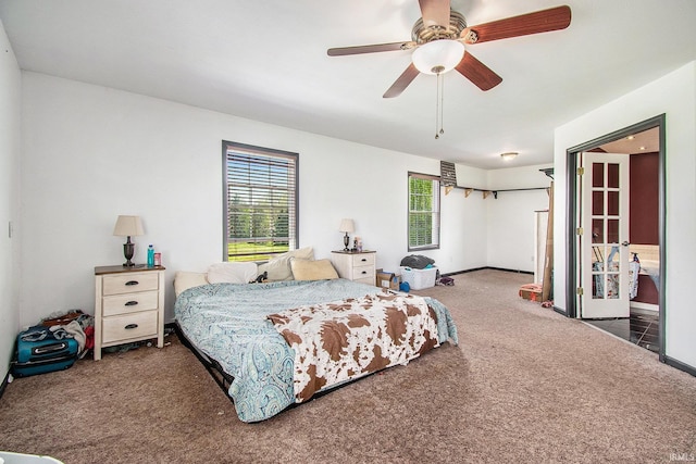 carpeted bedroom with baseboards and a ceiling fan