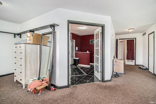 corridor with dark colored carpet and baseboards