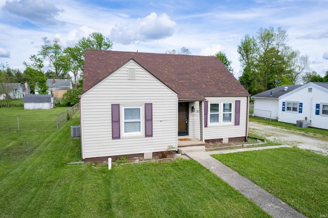 view of front of house with a shingled roof and central AC