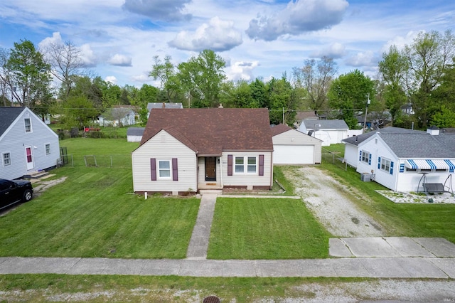view of front of house with a front lawn, an outbuilding, a garage, central AC unit, and a residential view