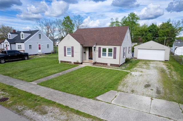 view of front of property featuring an outdoor structure, a garage, a front yard, and roof with shingles