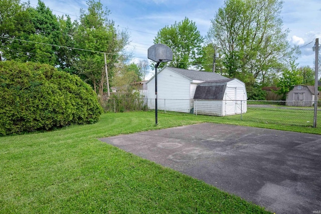 view of yard featuring a storage shed and an outbuilding