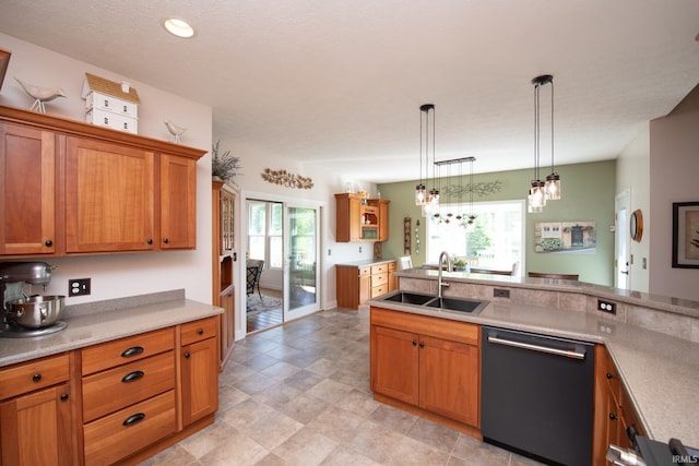 kitchen featuring dishwasher, a sink, brown cabinetry, and pendant lighting