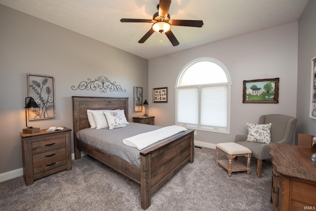 carpeted bedroom featuring baseboards and ceiling fan