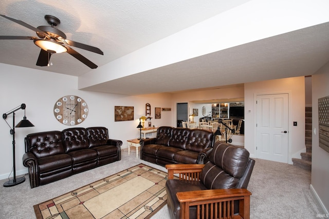 living area with carpet flooring, a ceiling fan, and baseboards
