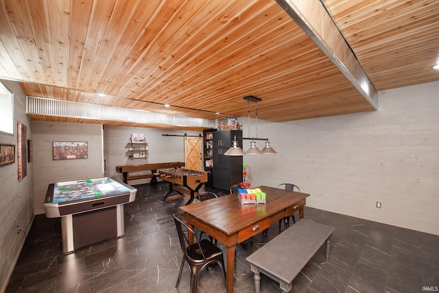 dining space with a barn door and wood ceiling
