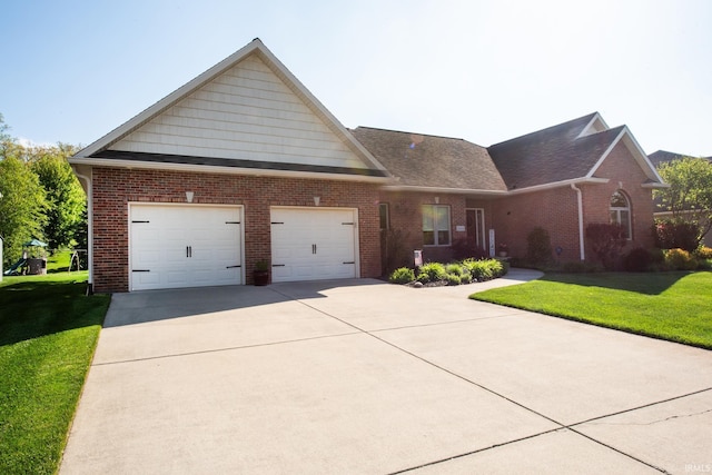 view of front of property with brick siding, a front yard, concrete driveway, and a garage