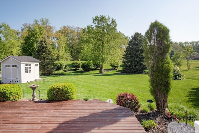 deck featuring a shed, a yard, and an outdoor structure