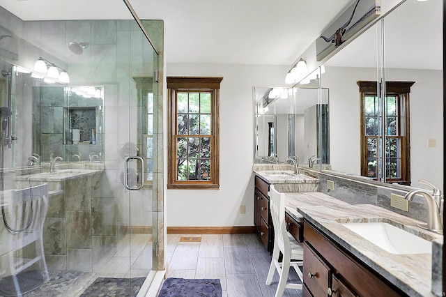 5571 Poff Rd, Martinsville, IN 46151 - bathroom featuring a stall shower, baseboards, and two vanities