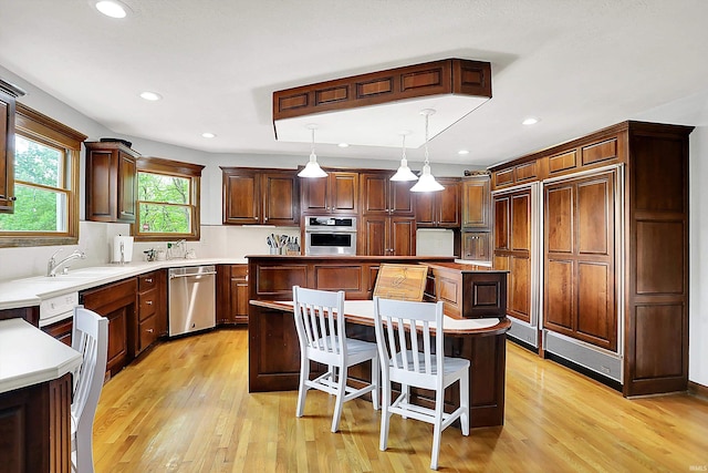 5571 Poff Rd, Martinsville, IN 46151 - kitchen with stainless steel appliances, a center island, a sink, light wood-type flooring, and recessed lighting