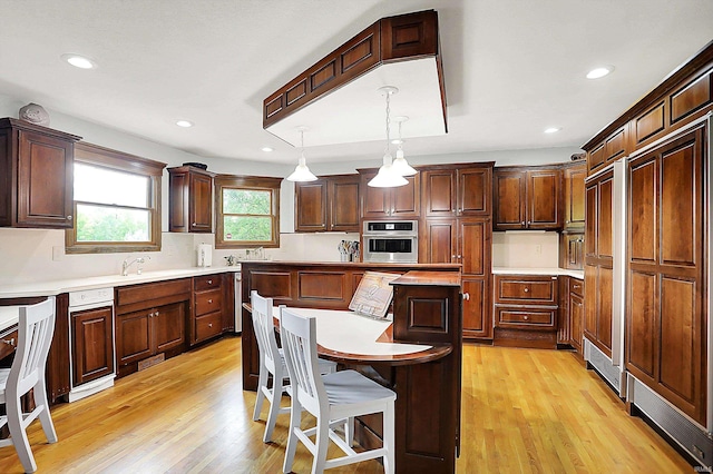 5571 Poff Rd, Martinsville, IN 46151 - kitchen featuring oven, a kitchen island, light countertops, light wood-style floors, and recessed lighting