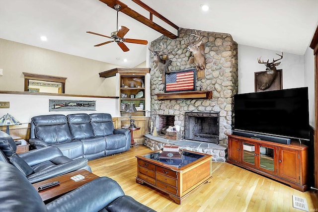 5571 Poff Rd, Martinsville, IN 46151 - living room featuring wood finished floors, a ceiling fan, and a stone fireplace