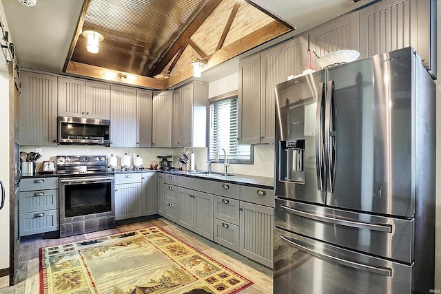 5571 Poff Rd, Martinsville, IN 46151 - kitchen featuring appliances with stainless steel finishes, a sink, gray cabinets, dark countertops, and light wood-style flooring