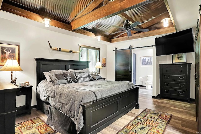 5571 Poff Rd, Martinsville, IN 46151 - bedroom with a barn door, beamed ceiling, wood ceiling, light wood-style flooring, and ensuite bathroom