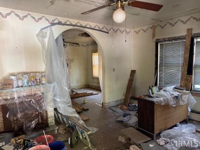 misc room featuring arched walkways and a ceiling fan