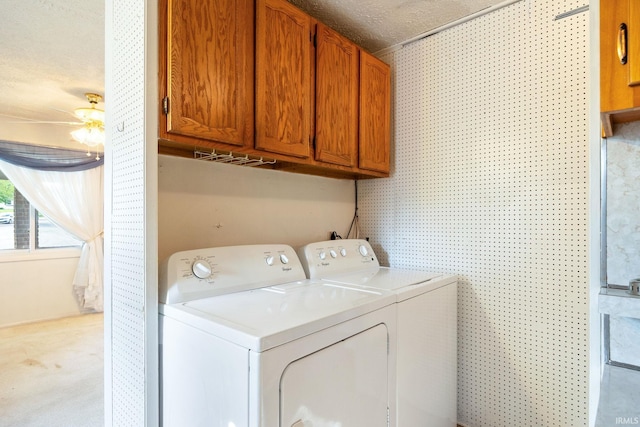 washroom featuring separate washer and dryer and cabinet space