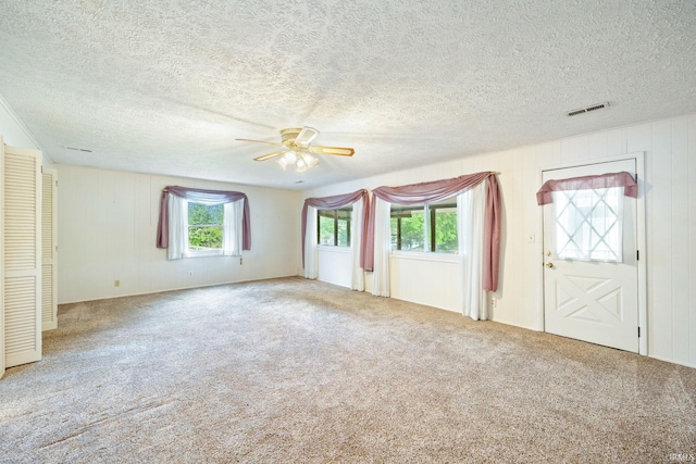 spare room featuring a ceiling fan, a textured ceiling, and carpet flooring