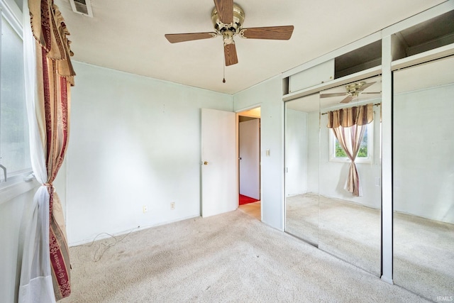 unfurnished bedroom featuring carpet and ceiling fan