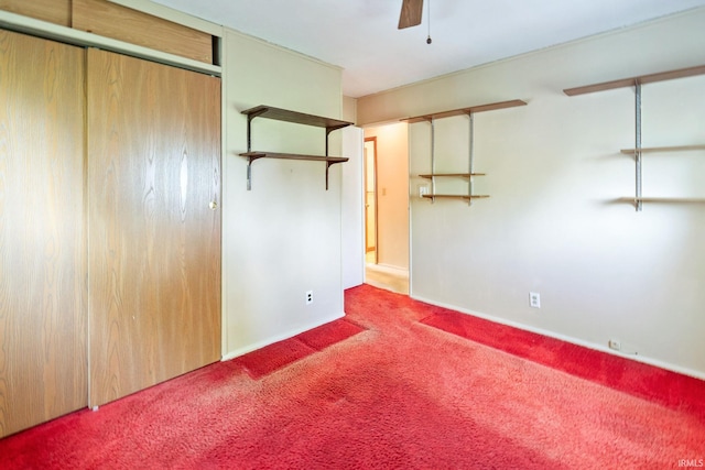 unfurnished bedroom featuring carpet, baseboards, a closet, and ceiling fan