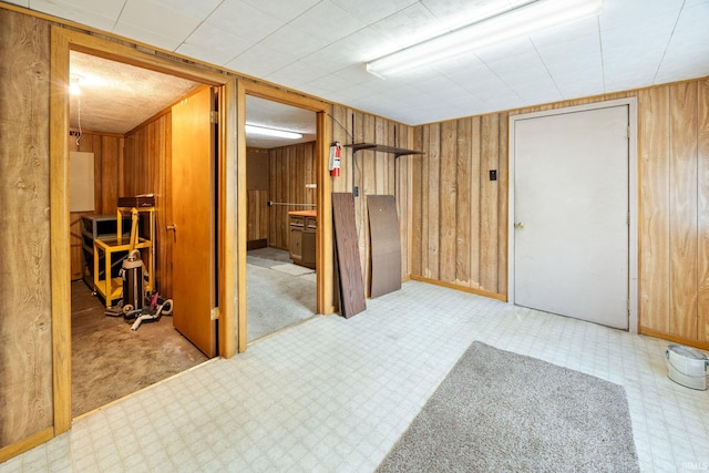 spare room featuring wood walls and tile patterned floors