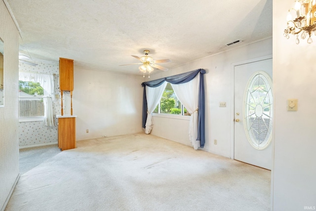 entryway featuring ceiling fan, a textured ceiling, and carpet