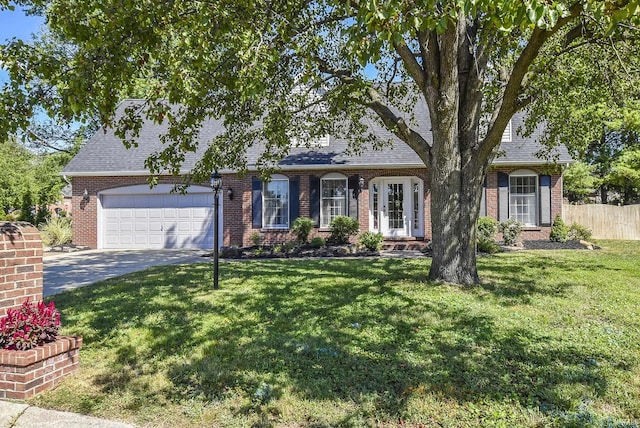 3010 Cypress Ct, Evansville, IN 47711 - view of front of home with an attached garage, asphalt driveway, brick siding, and roof with shingles