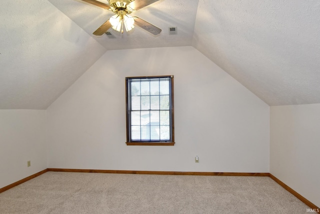 3010 Cypress Ct, Evansville, IN 47711 - bonus room featuring a textured ceiling, light carpet, vaulted ceiling, a ceiling fan, and baseboards