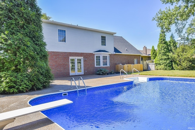 3010 Cypress Ct, Evansville, IN 47711 - outdoor pool featuring french doors, a patio, a diving board, and fence