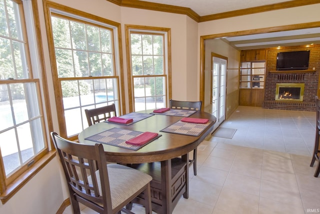 3010 Cypress Ct, Evansville, IN 47711 - dining space with light tile patterned flooring, plenty of natural light, crown molding, and a brick fireplace
