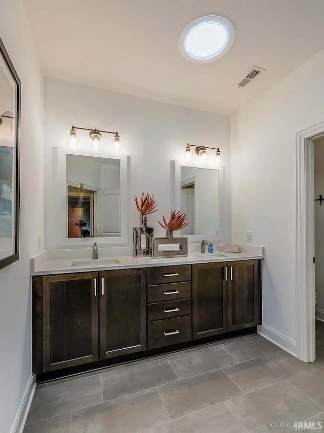 571 Tamarind Dr, West Lafayette, IN 47906 - full bathroom featuring double vanity, baseboards, and tile patterned floors