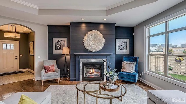 571 Tamarind Dr, West Lafayette, IN 47906 - living area with a tray ceiling, arched walkways, wood finished floors, baseboards, and recessed lighting