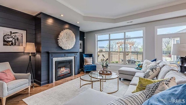 571 Tamarind Dr, West Lafayette, IN 47906 - living room with ornamental molding, a glass covered fireplace, wood finished floors, recessed lighting, and a raised ceiling