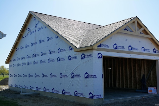 view of property exterior with a shingled roof