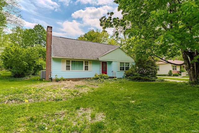 single story home with a chimney, a front lawn, and roof with shingles