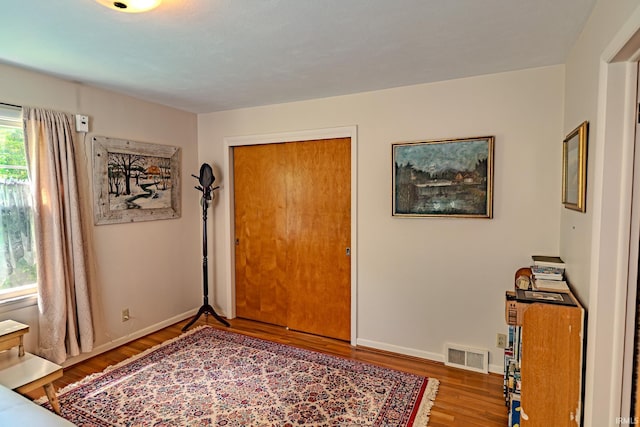 foyer featuring wood finished floors and baseboards