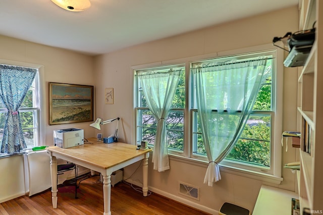 home office featuring wood finished floors and baseboards