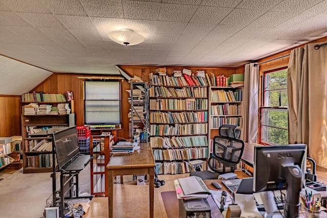 office area featuring wooden walls and built in shelves