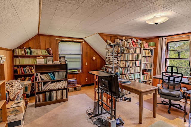 home office with wooden walls, lofted ceiling, and carpet flooring