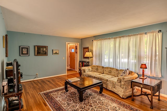 living room with baseboards and hardwood / wood-style flooring