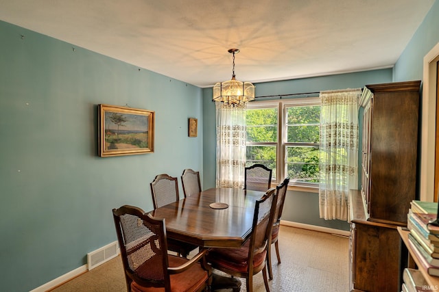 dining space featuring a chandelier, baseboards, and carpet floors