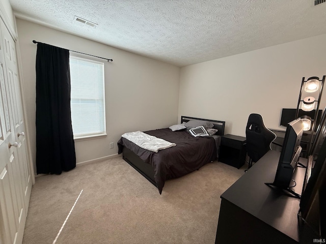 bedroom with carpet, a textured ceiling, a desk, and baseboards