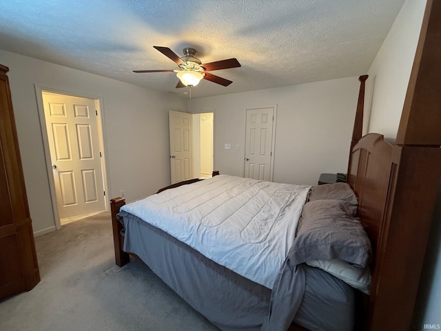 bedroom featuring light carpet, ceiling fan, a textured ceiling, and baseboards