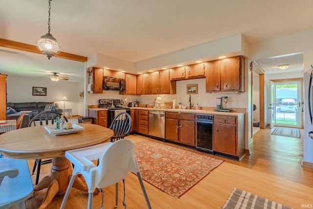 1918 Mckibben St, Wabash, IN 46992 - kitchen featuring stainless steel dishwasher, black microwave, a sink, light wood-style floors, and light countertops