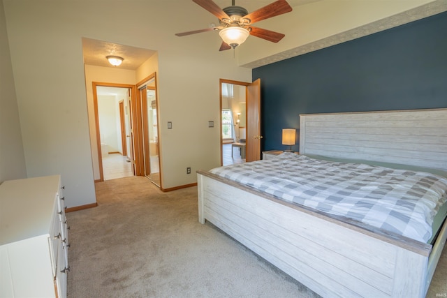 bedroom with light colored carpet, baseboards, and a ceiling fan
