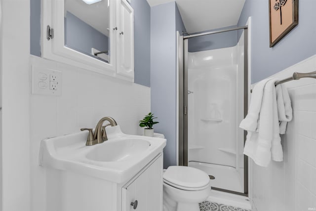 full bath featuring a shower stall, tile walls, decorative backsplash, toilet, and vanity