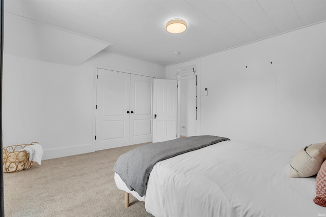 bedroom with carpet floors, a closet, and baseboards