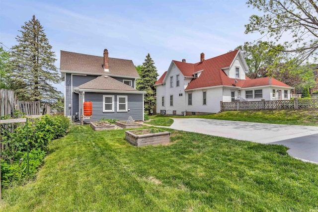 back of house with a garden and a chimney